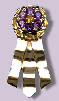 14K Gold Best in Specialty Show Rosette with Cluster top of Rubies and Sapphires surrounding a center Diamond.