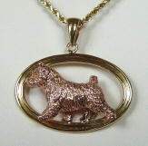 14K Gold Norwich Terrier in PINK GOLD trotting in Yellow Gold Oval